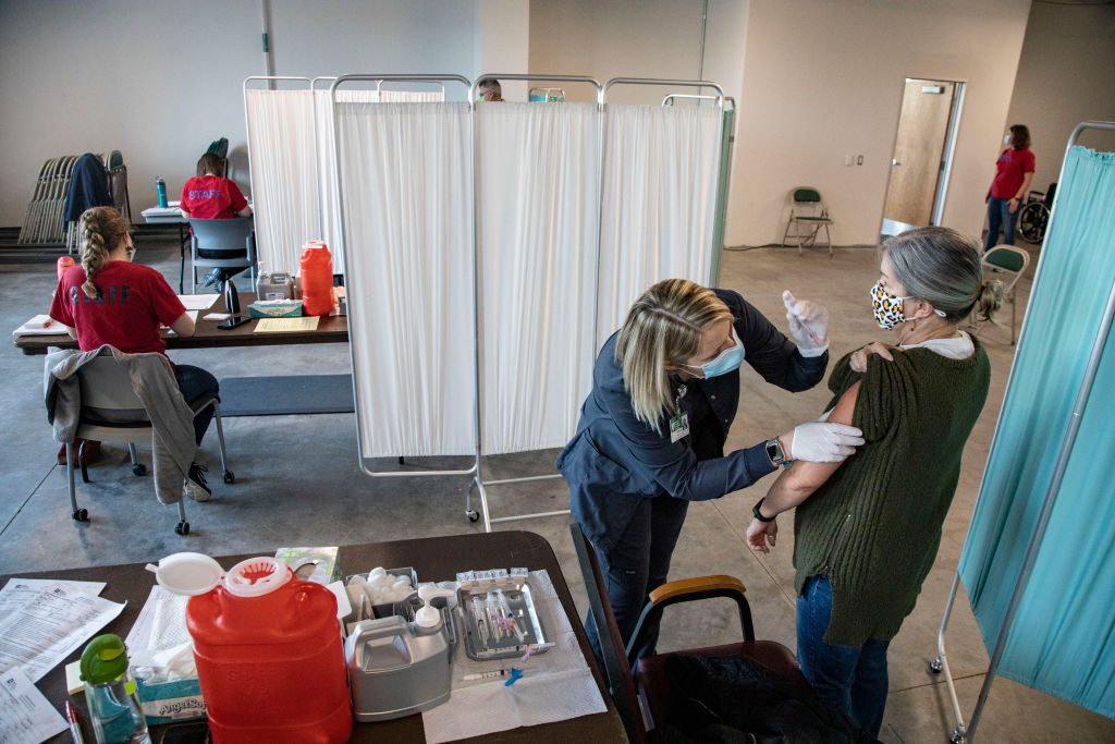 Cristi Hunkler, a retired school teacher receives the...