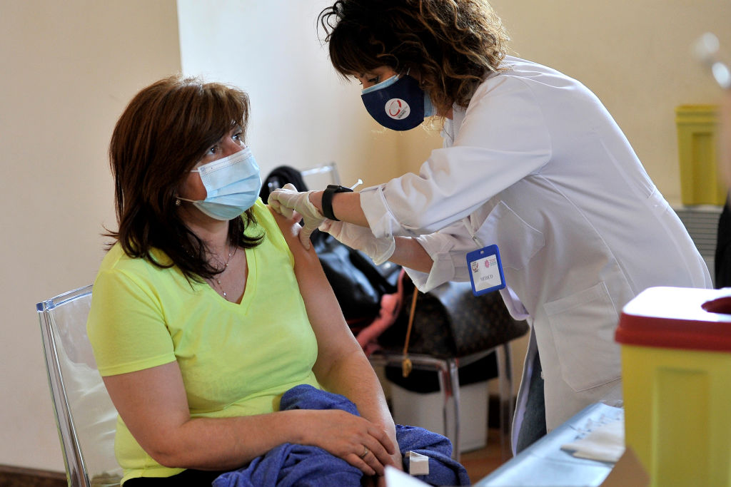 Nurse injects a dose of Johnson & Johnson vaccine to a...