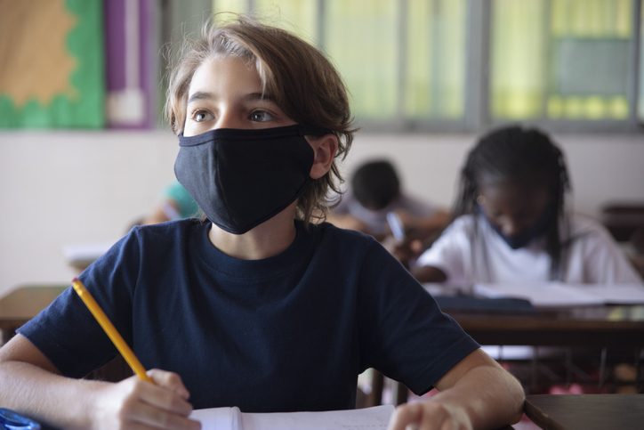 Pupils doing classwork at classroom. Covid-19 Concepts