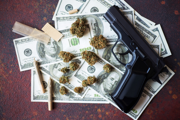 Black gun, marijuana bumps and dollar bills