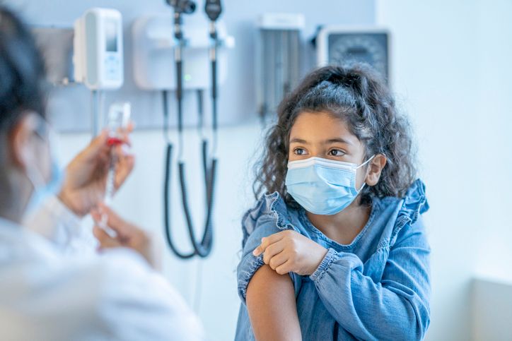Doctor Preparing a Young Patients Vaccine