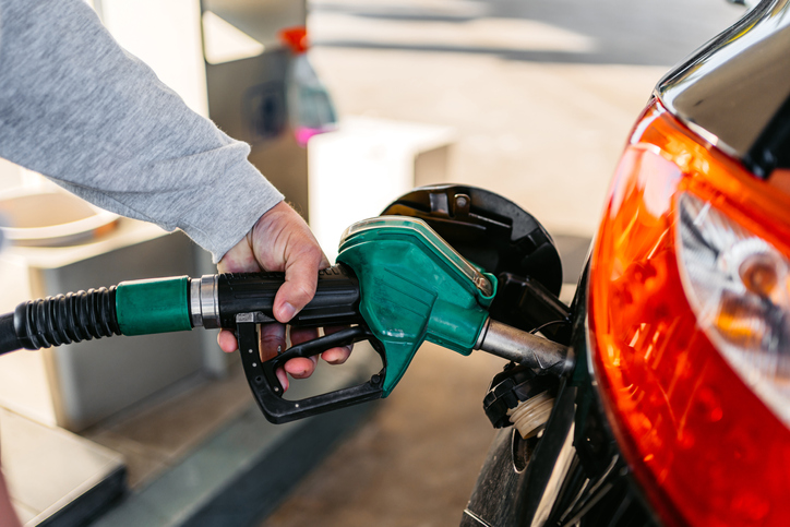 Man Pouring Fuel In His Car At The Gas Station