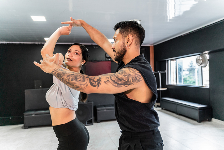 Young couple rehearsing in a dance studio