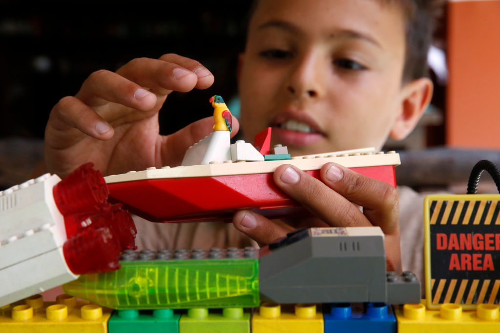 10-year-old boy playing with lego.