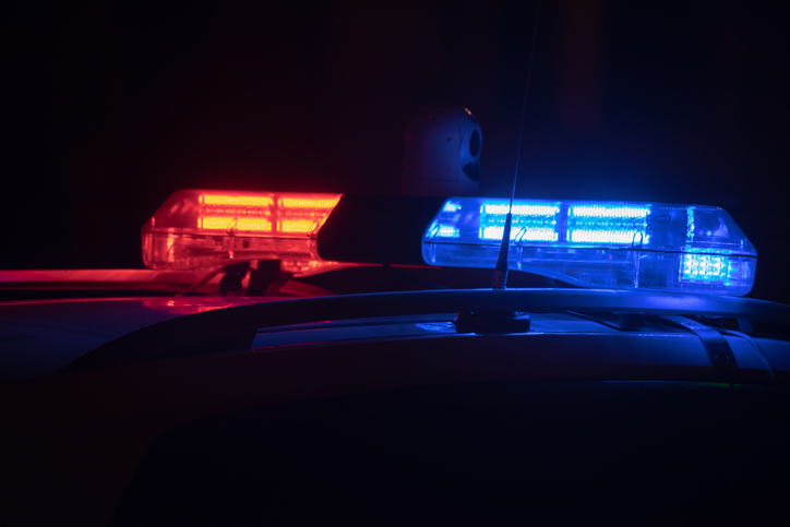 Police car lights at night in city with selective focus and bokeh.