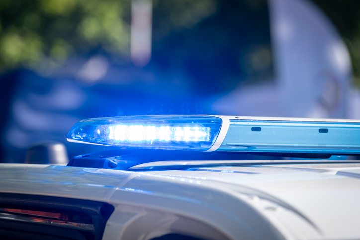 Blue flashlight on top of a police car