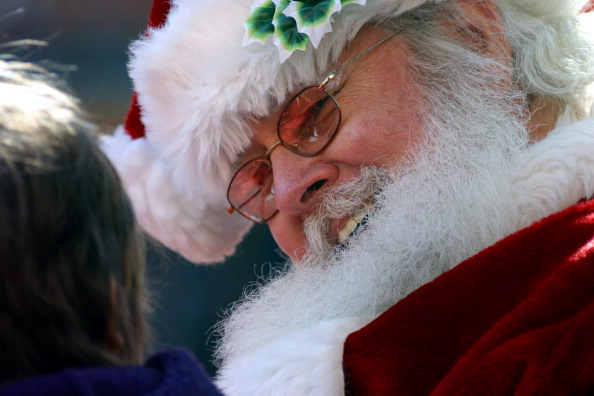 BOULDER, COLO. - November 28, 2003 - Santa Claus, also known during some parts of the year as Ed Meyers of Lakewood, chats with three-and-a-half-year-old Noel Holden of Pasadena, Calif. on the Pearl Street Mall in Boulder Friday afternoon,