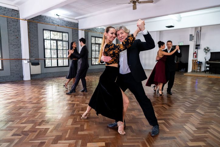 Portrait of a couple dancers dancing tango in a dance studio