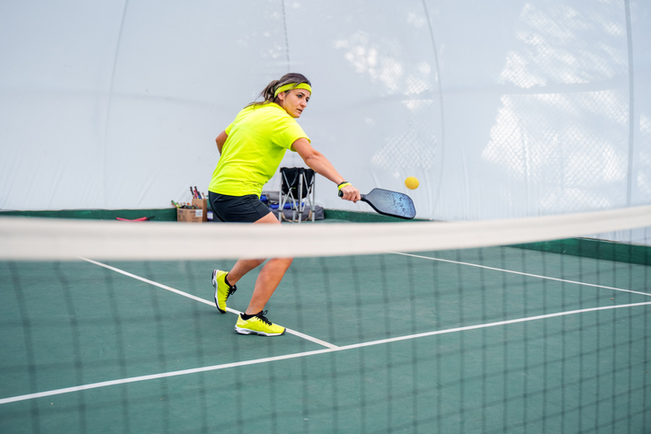 A mature woman Practicing Pickleball Indoors