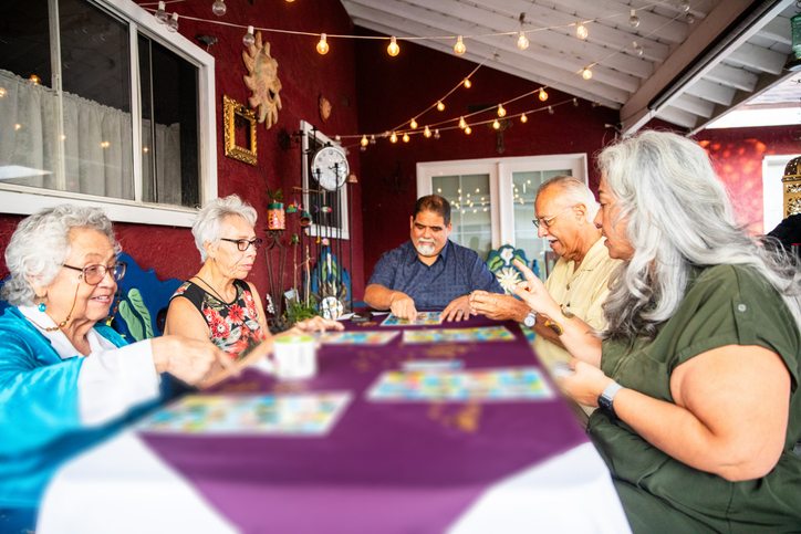 Mexican Family Playing A Game after Dinner