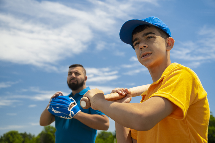 Father and son prepping for a baseball game