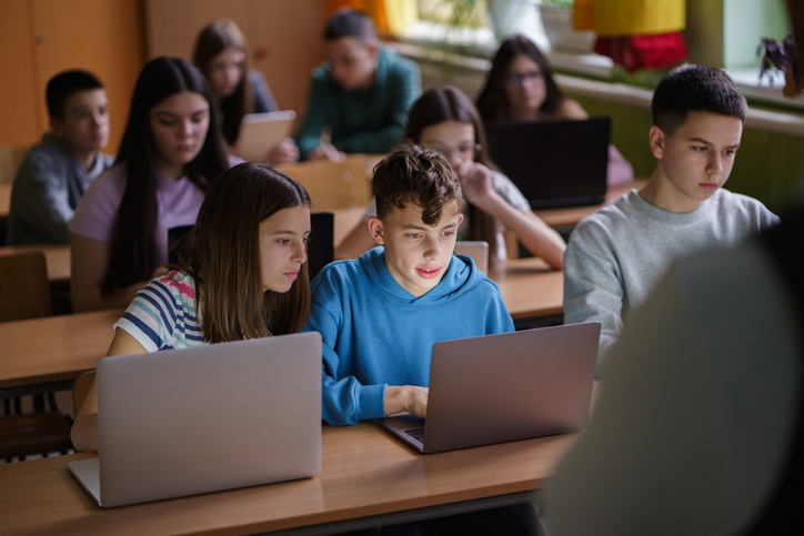 Children use laptops in class at school