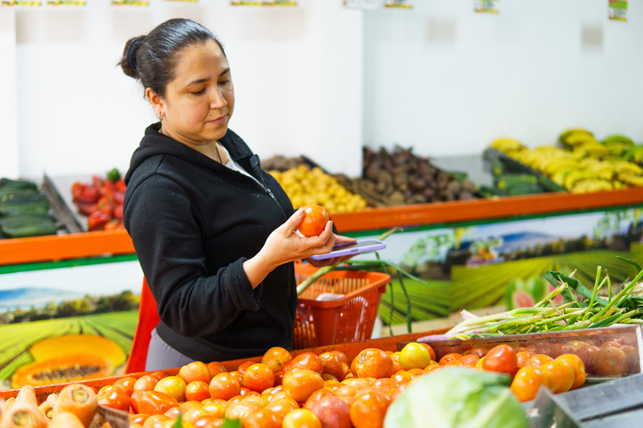 Female Domestic Worker Shopping for Lunch with Tomato and Basket