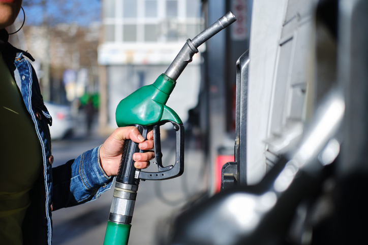 Woman refueling her car at a gas station in the city. unrecognizable person. Transport and mobility concept