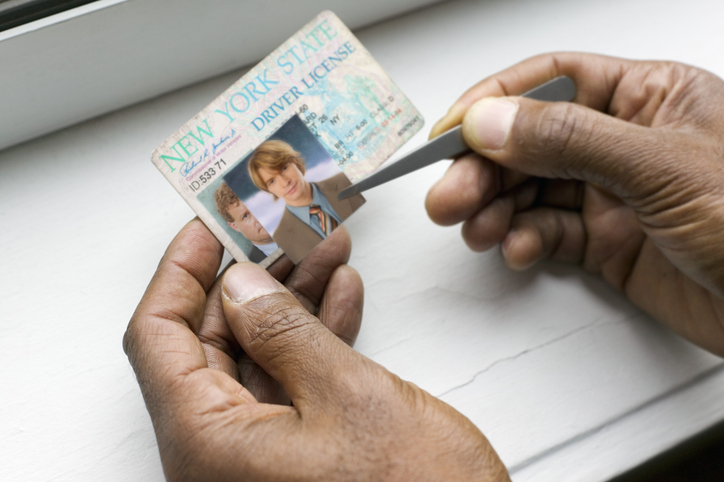 Hands making fake ID
