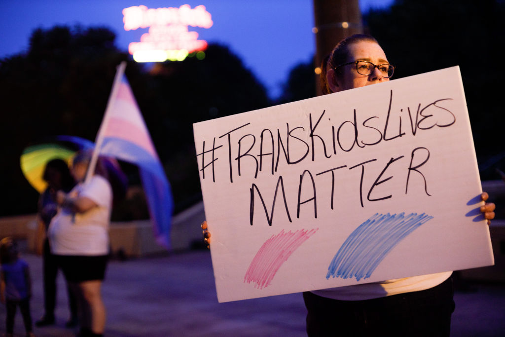 Transgender rights advocate holds a sign outside the Ohio...