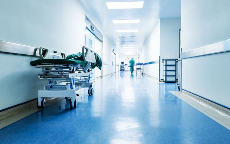 Doctors or nurses walking in hospital hallway, blurred motion