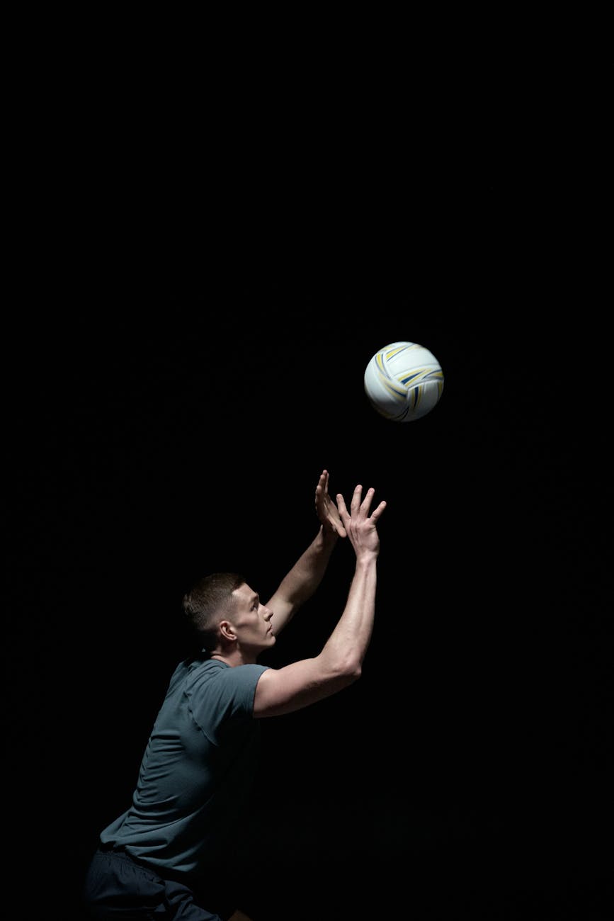 photo of man playing volleyball