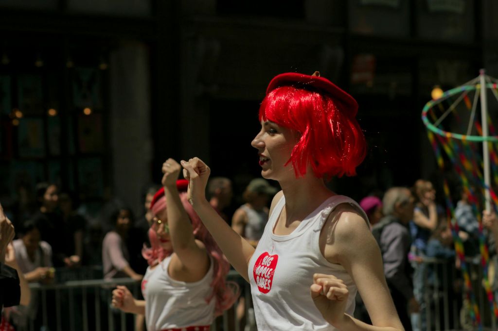 woman in white tank top with red hair