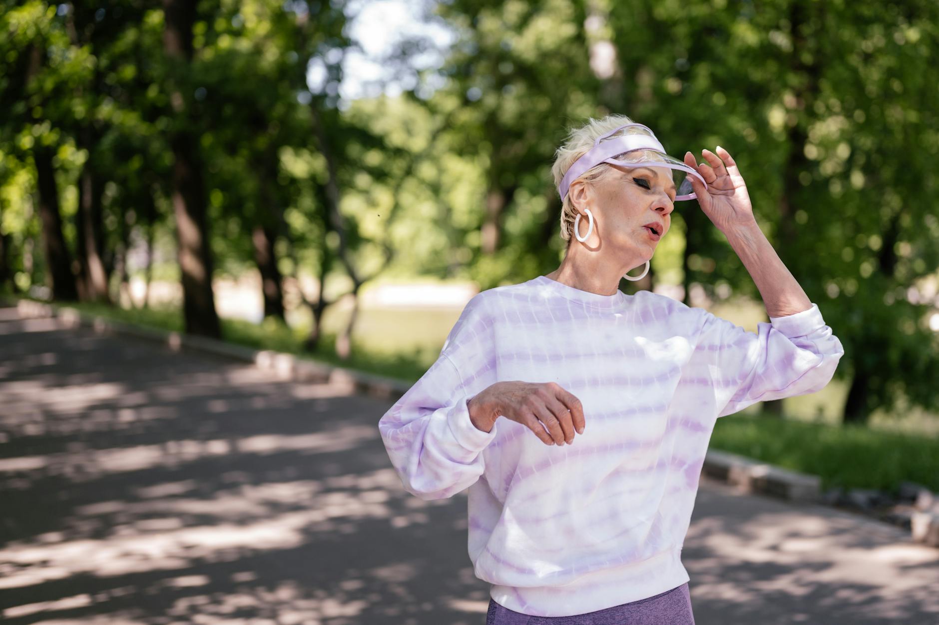 elderly woman wearing a sweater and earrings