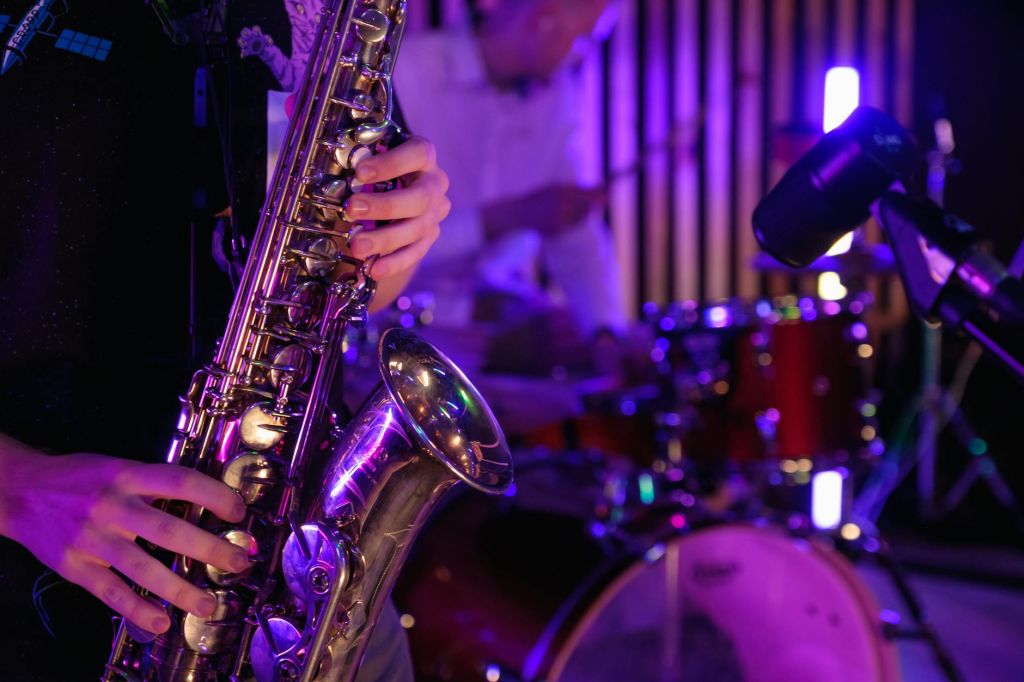 close up photo of man playing saxophone
