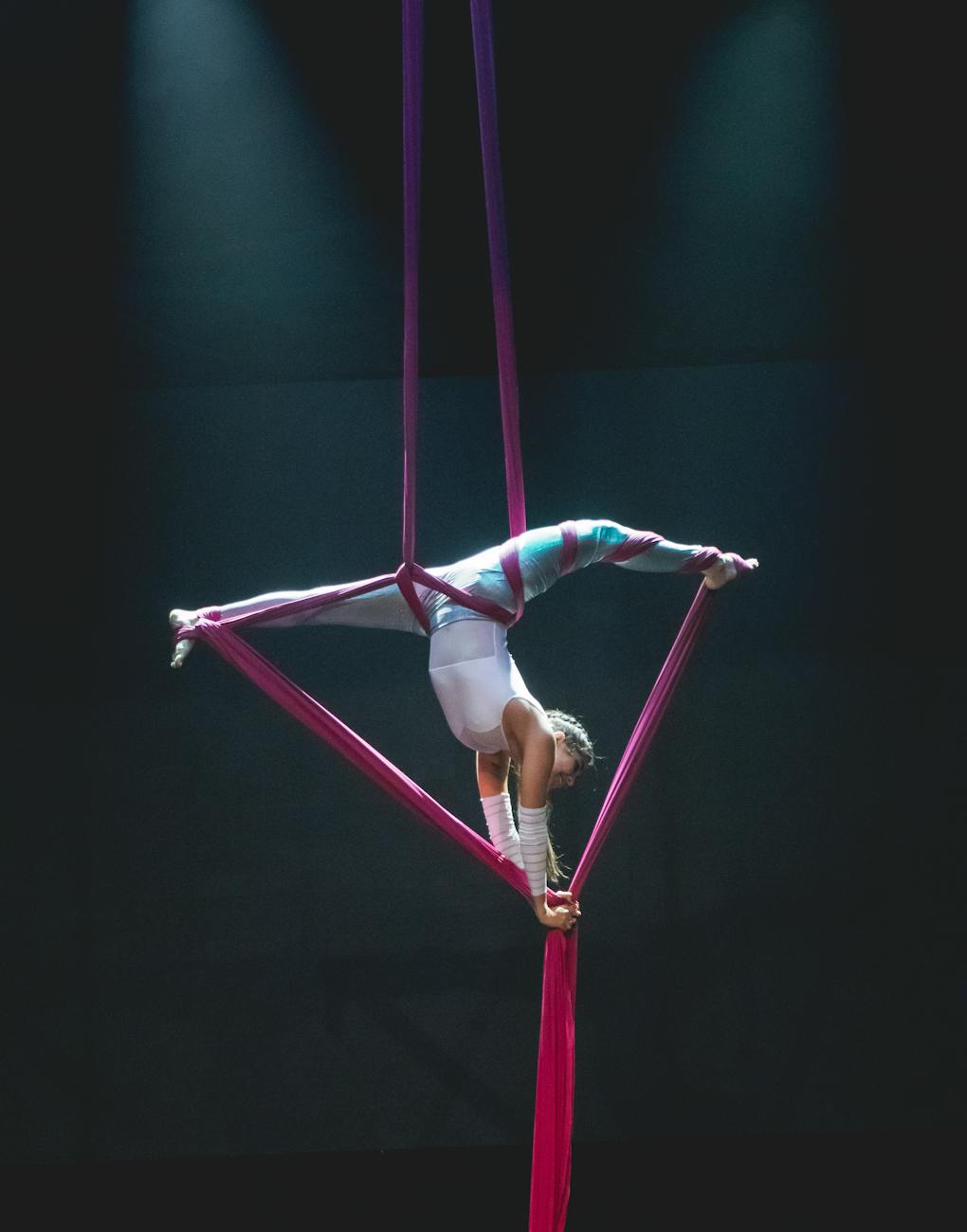 aerial silk performer in dramatic pose on stage