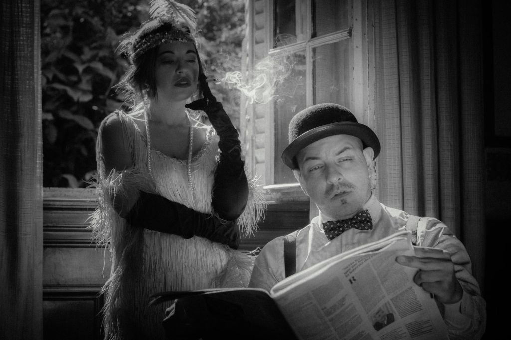 man in hat and woman in flapper dress