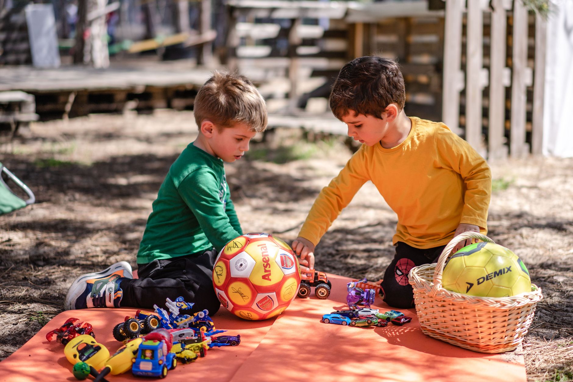 little boys playing with toy cars
