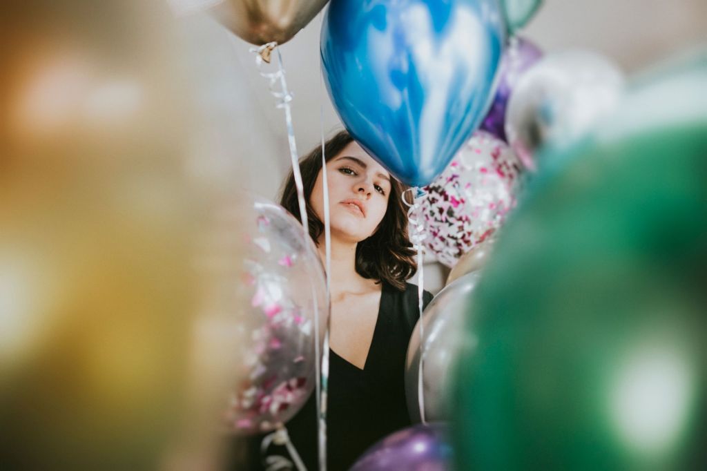 woman standing near balloons