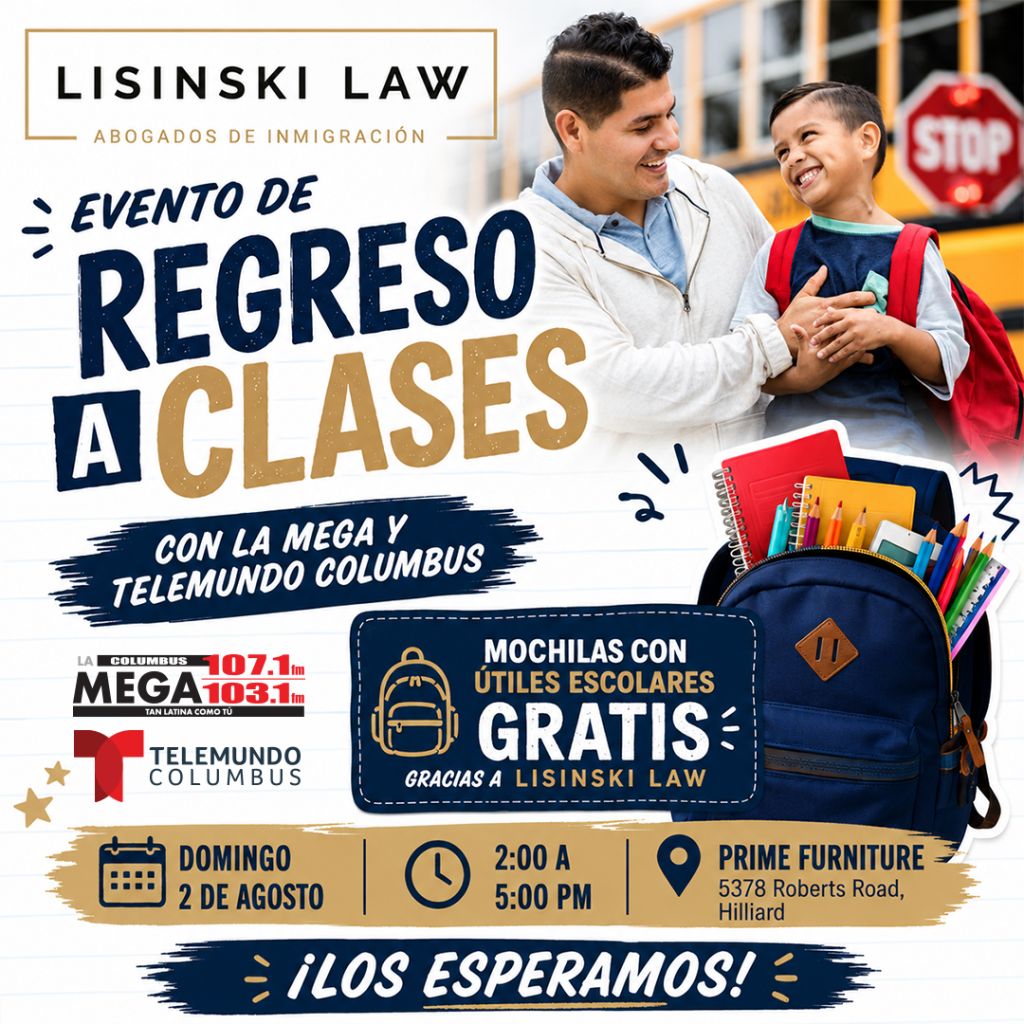 A man and a young boy standing in front of a sign for "Lisinski Law" immigration attorneys. The sign advertises a "Regreso a Clases" (Back to School) event with Telemundo Columbus radio stations.