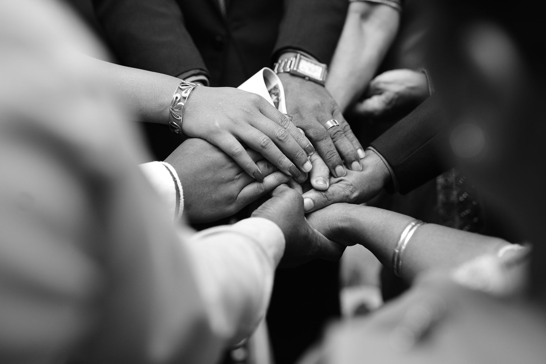 people holding hands in black and white