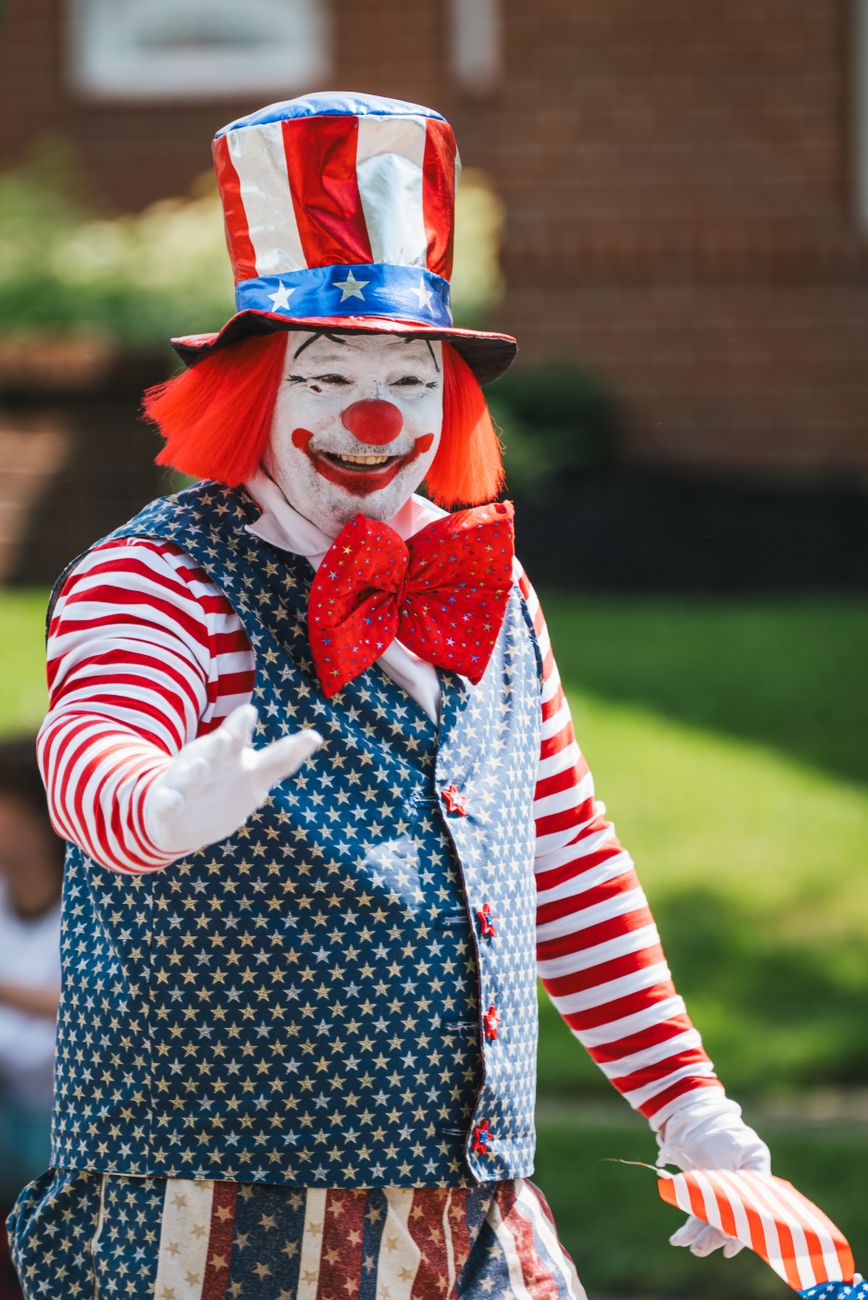 man standing in clown costume
